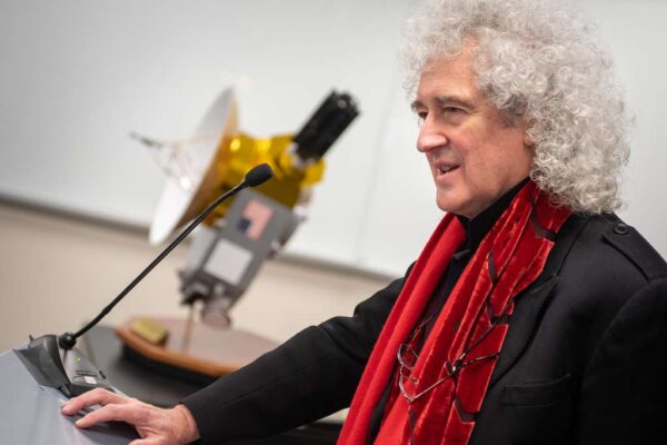 Astrophysicist Brian May, former lead guitarist of Queen, at NASA conference at Johns Hopkins University to discuss the upcoming New Horizons flyby of Ultima Thule, an object in the Kuiper Belt.